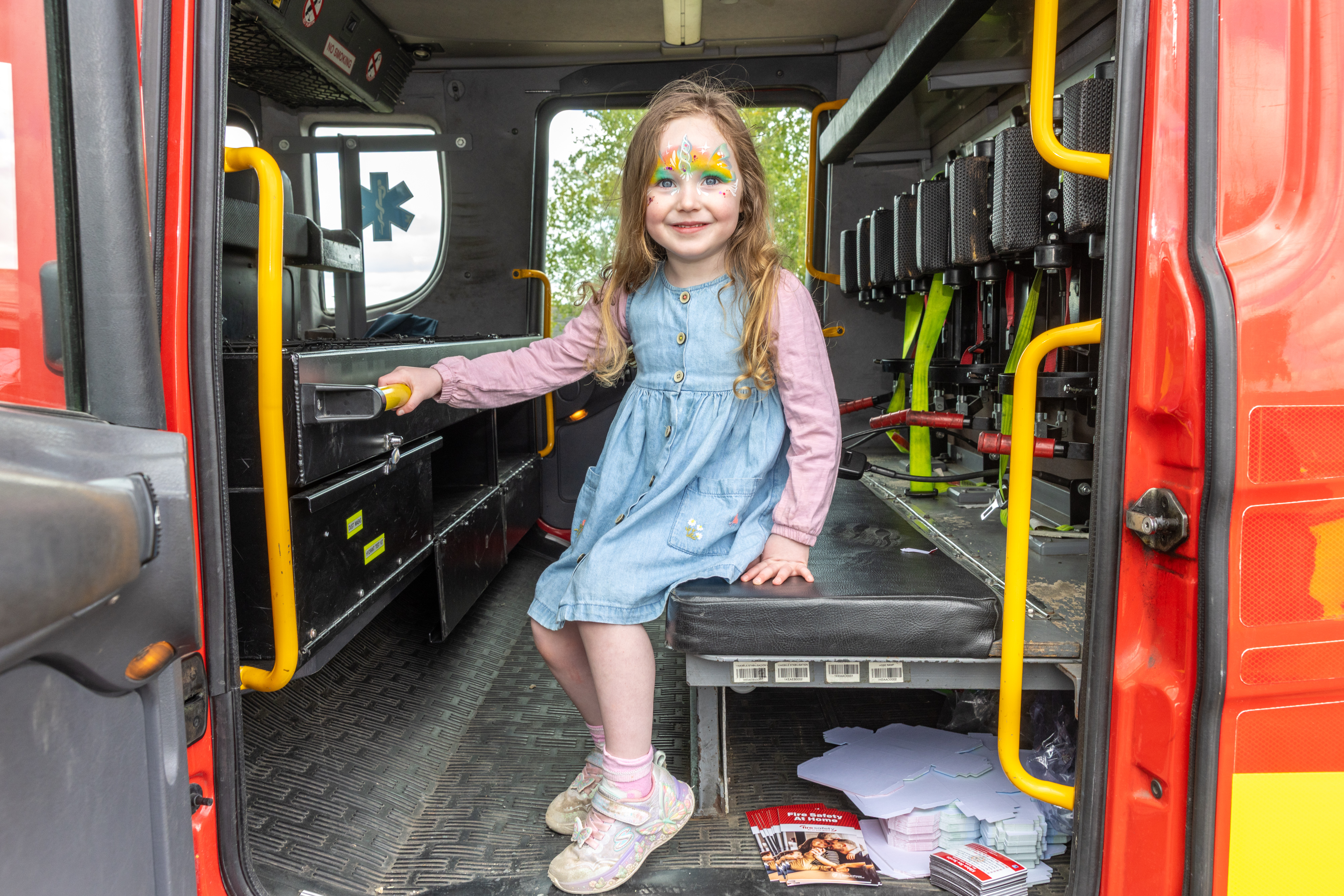 Child in fire truck. 